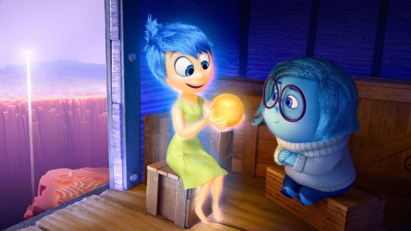 Inside Out - Joy holding a memory orb beside Sadness