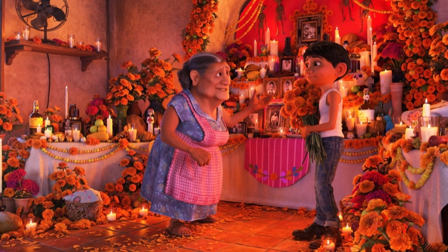 Coco - Abuelita and Miguel in front of the family ofrenda