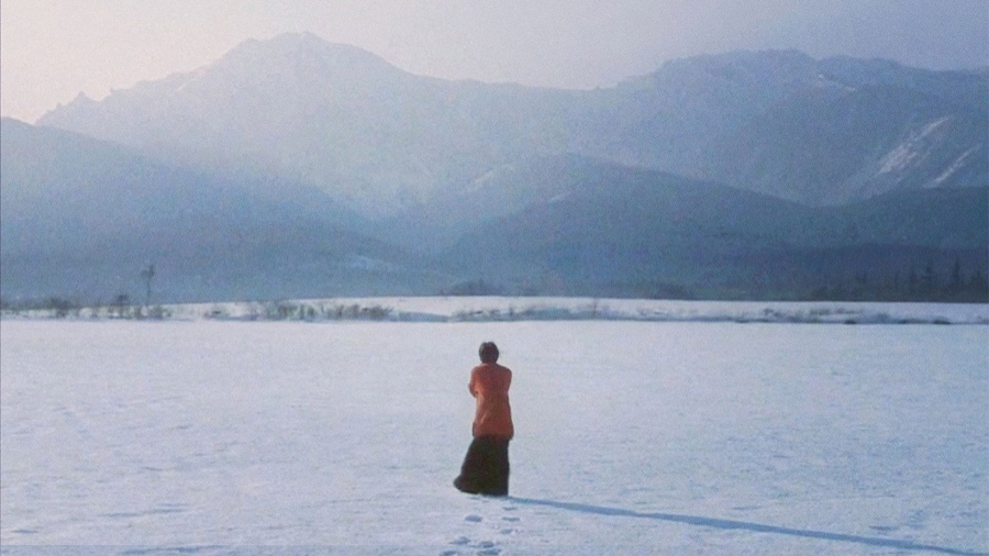 Love Letter (1995) - a lone figure on a snowfield facing the mountains